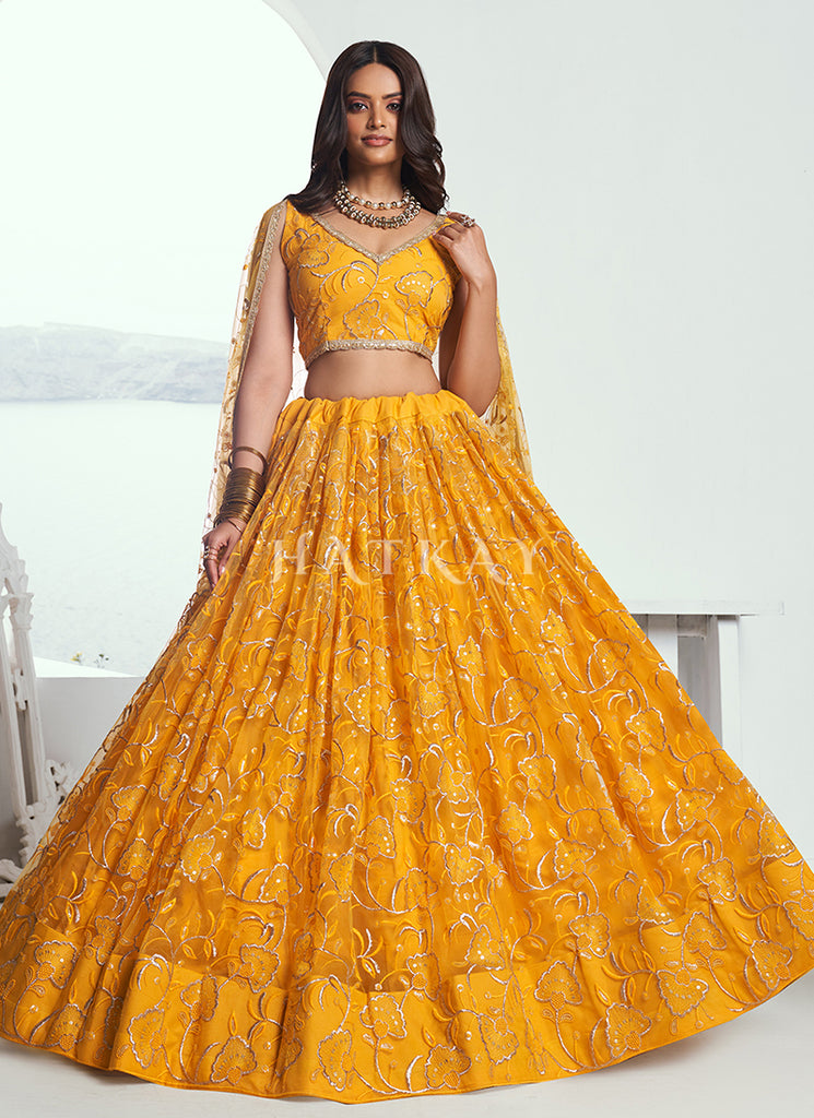 Add a touch of glitz and glamor to your traditional outfit collection with the gorgeous and bold lehenga choli from Hatkay's designer Indian collection.
