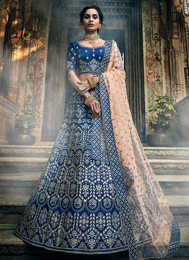 This cerulean blue raw silk lehenga choli is hand embellished with adda  work over a sreen-printed base with peach-gold PK tissue finishing… |  Instagram